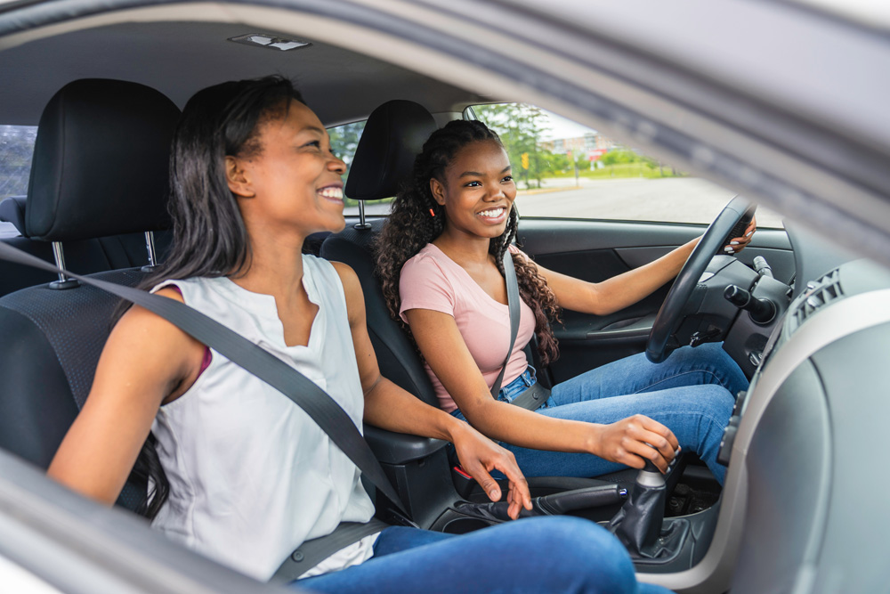 Young-black-teenage-driver-seated-in-her-new-car