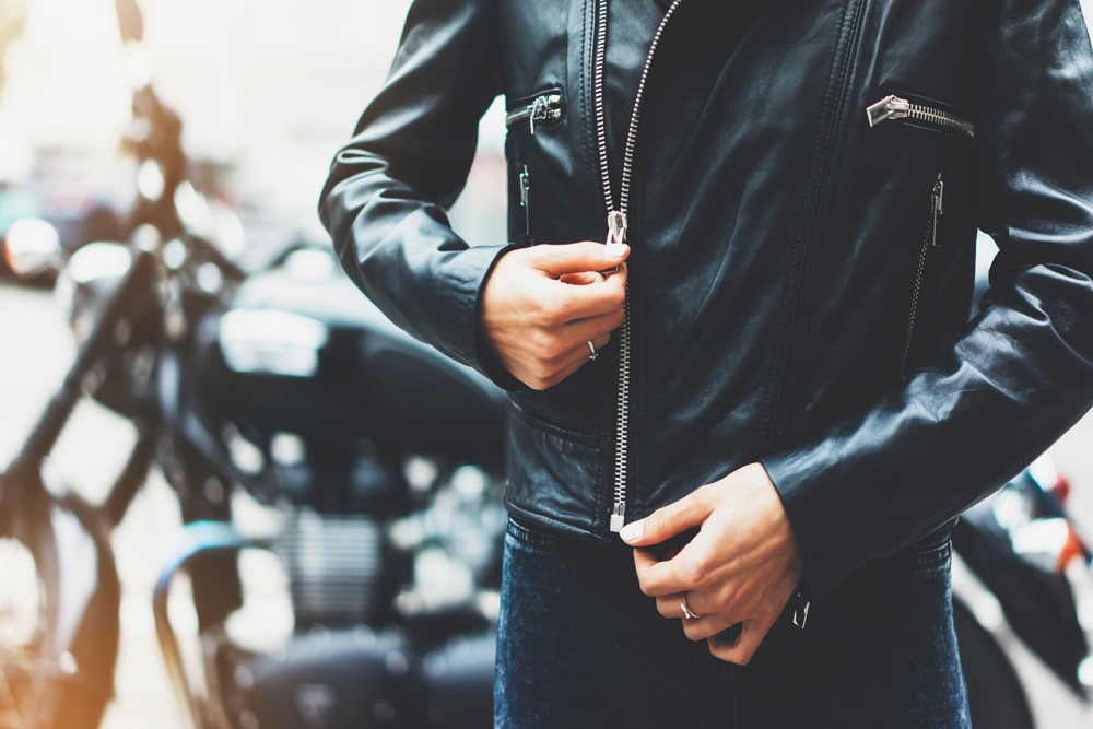 black-leather-jacket-on-background-motorcycle-in-sun-flare-atmospheric-city
