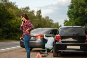 Male and female drivers on road, car accident. Automobile crash. Broken automobile or damaged vehicle, auto collision on highway