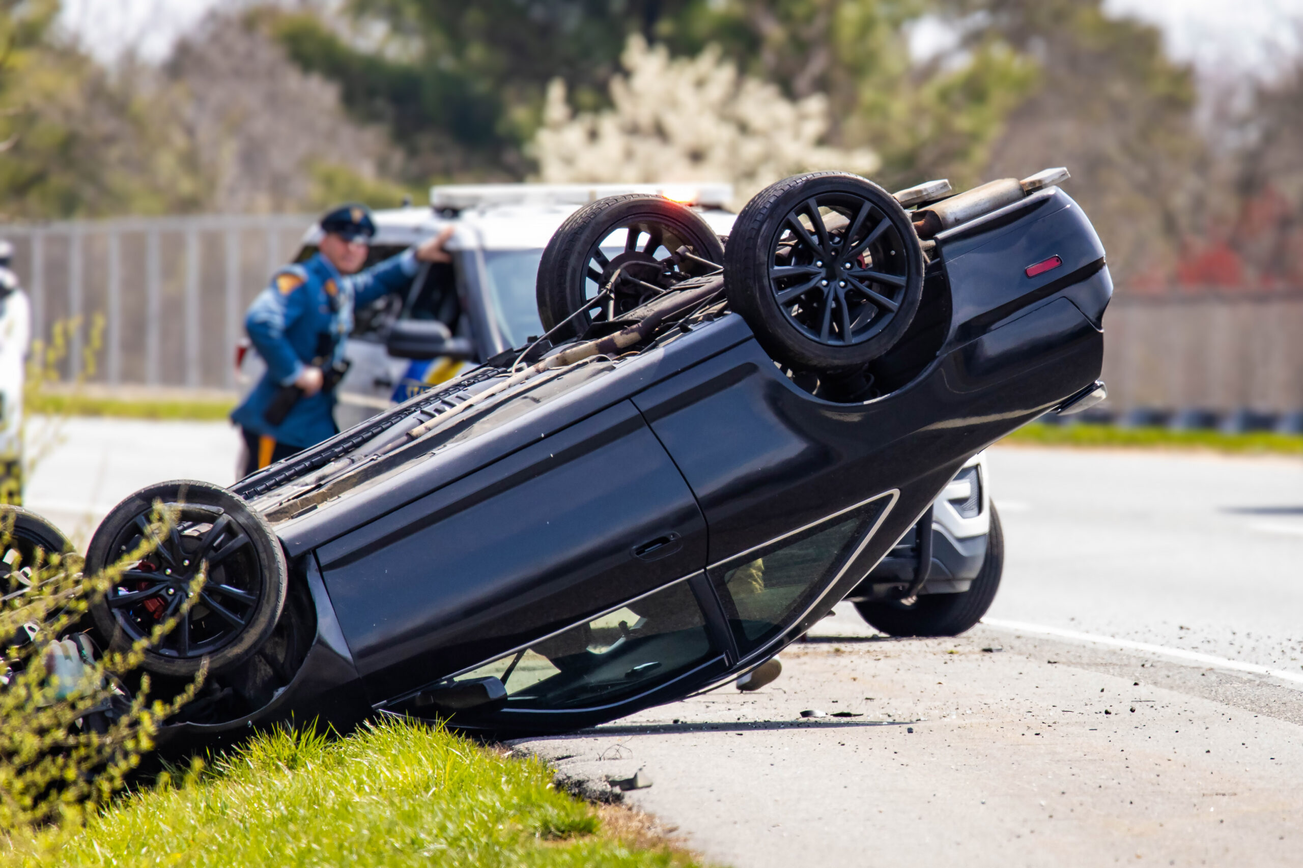 Vehicle rollover highway road accident with police in the back