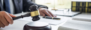 Judge gavel with Justice lawyers, Businessman in suit or lawyer working on a documents in courtroom. Legal law, advice and justice concept.