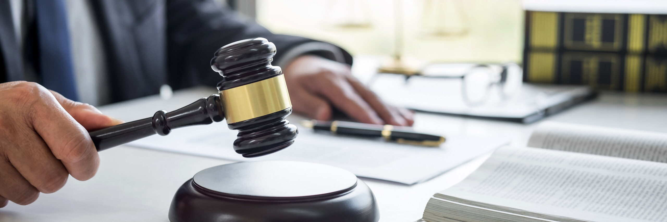 Judge gavel with Justice lawyers, Businessman in suit or lawyer working on a documents in courtroom. Legal law, advice and justice concept.