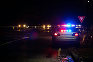 Police emergency flash lights at night from the back on highway road