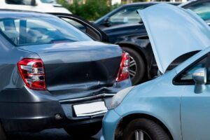 Car accident in parking lot during day with damaged vehicles
